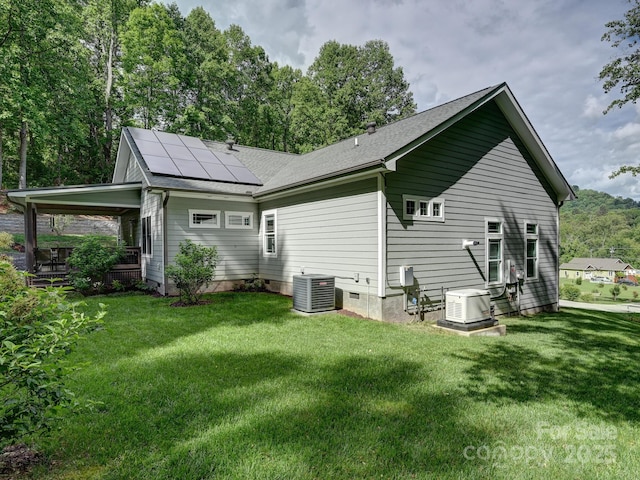 26 Addison Fisher Way, Asheville, NC 28805 - back of property featuring roof mounted solar panels, central air condition unit, a lawn, and a cooling unit