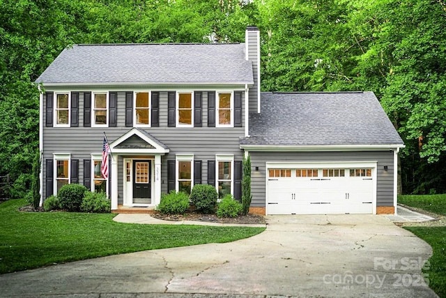 3314 Mara Ct, Matthews, NC 28105 - colonial-style house with a chimney, driveway, a garage, a front lawn, and roof with shingles