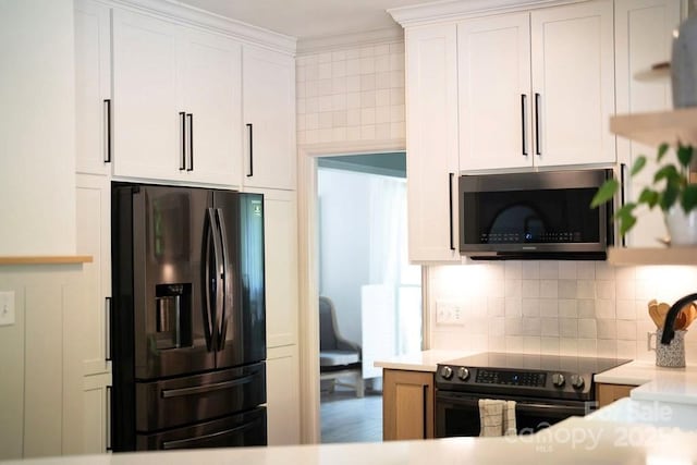 3314 Mara Ct, Matthews, NC 28105 - kitchen featuring black appliances, backsplash, white cabinets, light countertops, and ornamental molding