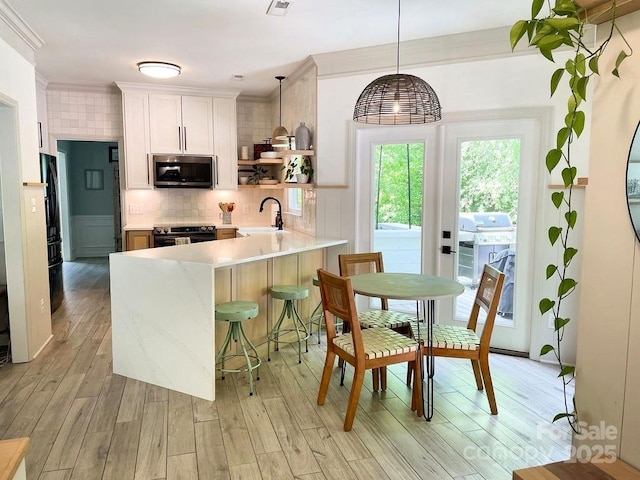 3314 Mara Ct, Matthews, NC 28105 - kitchen featuring stainless steel microwave, electric range oven, open shelves, a sink, and light countertops