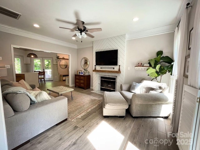 3314 Mara Ct, Matthews, NC 28105 - living room featuring ceiling fan, crown molding, a large fireplace, wood finished floors, and recessed lighting
