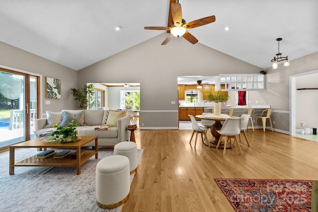 1827 Beckner Rd, Lexington, NC 27292 - living area featuring high vaulted ceiling, plenty of natural light, ceiling fan, light wood finished floors, and baseboards