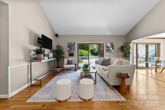 1827 Beckner Rd, Lexington, NC 27292 - living room with plenty of natural light, wood finished floors, high vaulted ceiling, and baseboards