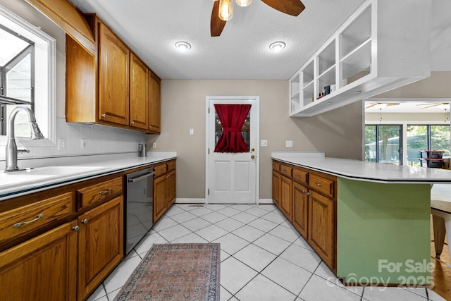 1827 Beckner Rd, Lexington, NC 27292 - kitchen featuring a ceiling fan, dishwasher, a sink, brown cabinets, and a peninsula