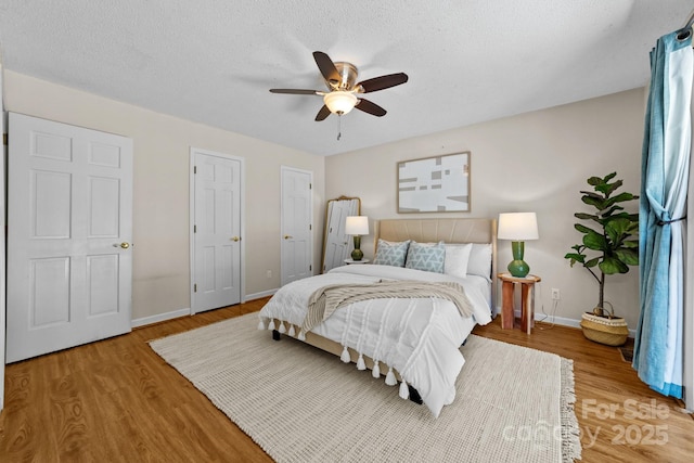 1827 Beckner Rd, Lexington, NC 27292 - bedroom with light wood-style floors, baseboards, ceiling fan, and a textured ceiling