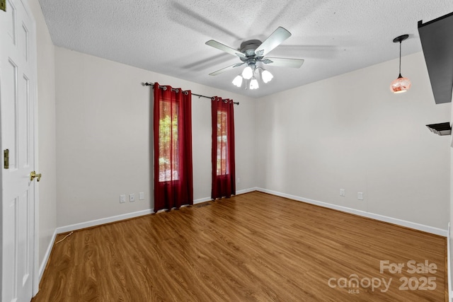 1827 Beckner Rd, Lexington, NC 27292 - unfurnished room featuring wood finished floors, a textured ceiling, baseboards, and ceiling fan