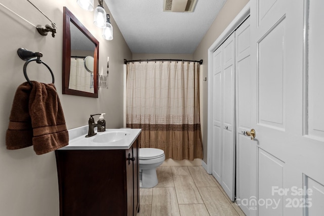 1827 Beckner Rd, Lexington, NC 27292 - bathroom featuring toilet, vanity, a textured ceiling, a closet, and curtained shower