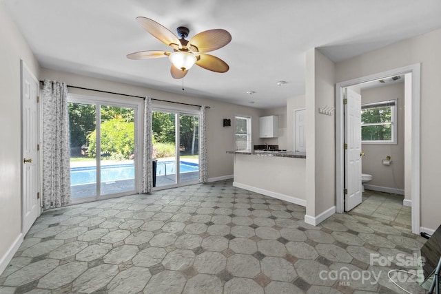 1827 Beckner Rd, Lexington, NC 27292 - unfurnished living room with baseboards, plenty of natural light, and a ceiling fan