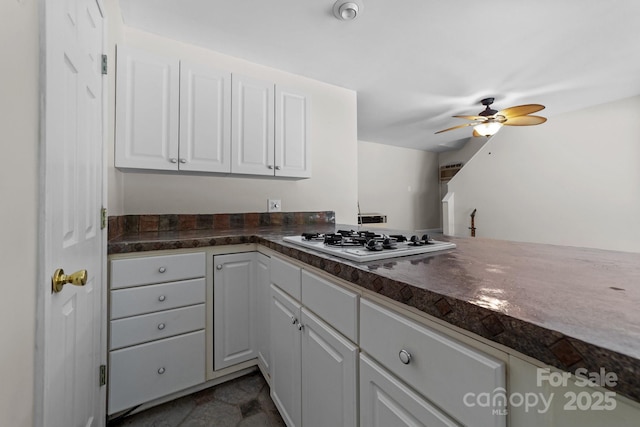 1827 Beckner Rd, Lexington, NC 27292 - kitchen with white cabinetry, dark countertops, white gas stovetop, and a ceiling fan