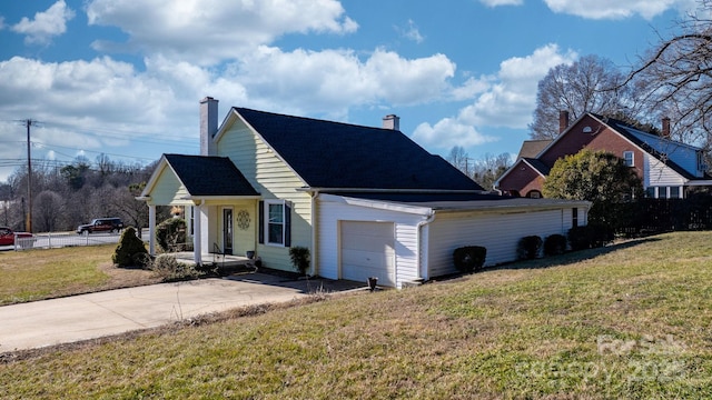 98 S Main St, Granite Falls, NC 28630 - view of home's exterior featuring concrete driveway, a yard, a garage, a porch, and a chimney