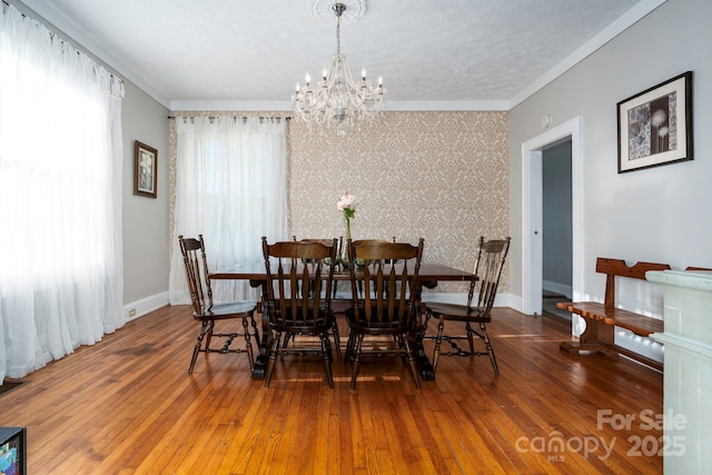 98 S Main St, Granite Falls, NC 28630 - dining room featuring a chandelier, hardwood / wood-style flooring, crown molding, and baseboards
