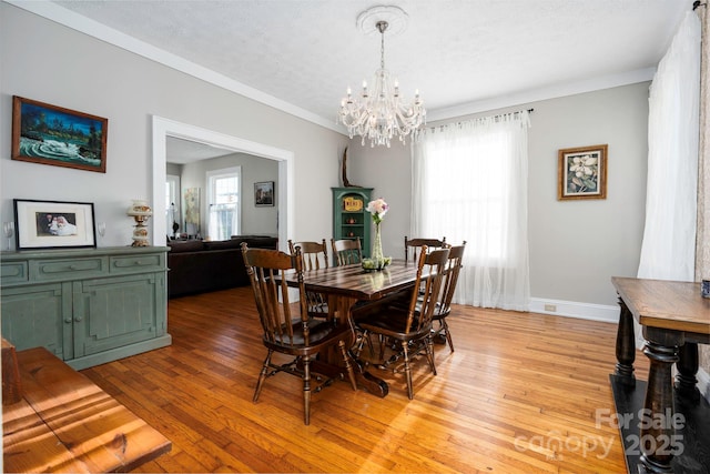 98 S Main St, Granite Falls, NC 28630 - dining space featuring a chandelier, light wood finished floors, crown molding, baseboards, and a textured ceiling