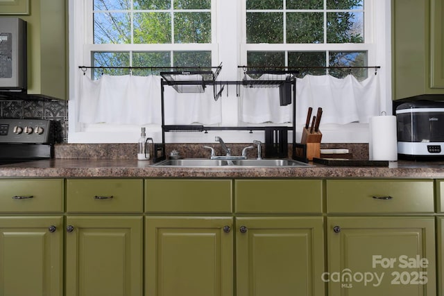 98 S Main St, Granite Falls, NC 28630 - kitchen with green cabinets, a sink, dark countertops, and electric range oven