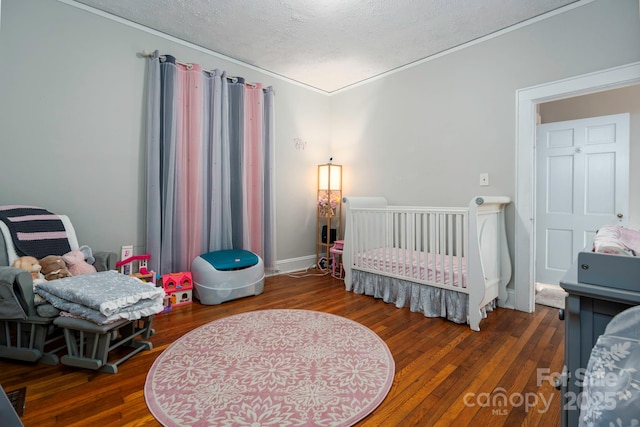 98 S Main St, Granite Falls, NC 28630 - bedroom with wood finished floors, crown molding, and a textured ceiling