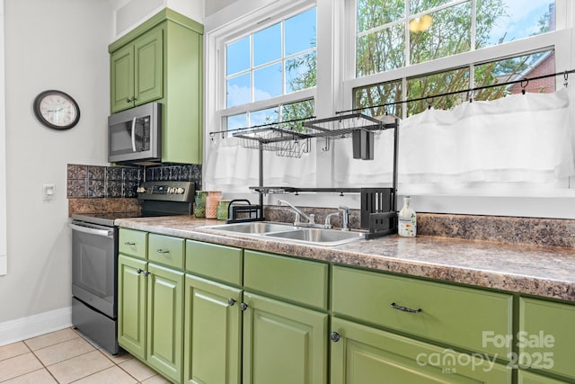 98 S Main St, Granite Falls, NC 28630 - kitchen featuring stainless steel appliances, light tile patterned floors, green cabinetry, and tasteful backsplash
