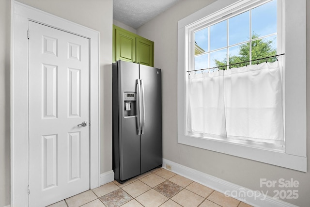 98 S Main St, Granite Falls, NC 28630 - kitchen featuring stainless steel fridge with ice dispenser, green cabinetry, light tile patterned floors, and a textured ceiling