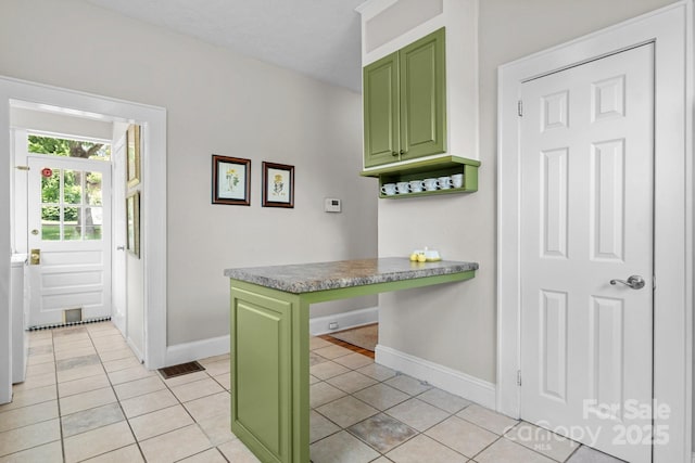 98 S Main St, Granite Falls, NC 28630 - kitchen with green cabinetry, light tile patterned floors, and a peninsula