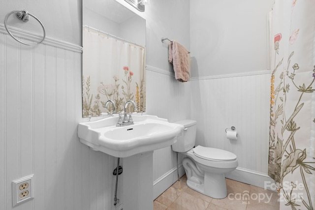 98 S Main St, Granite Falls, NC 28630 - bathroom with a wainscoted wall, tile patterned flooring, and a shower with curtain