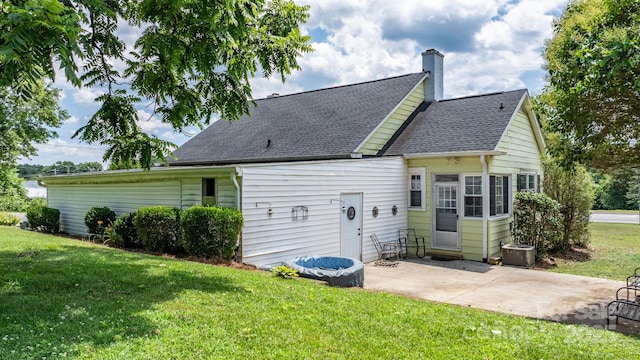 98 S Main St, Granite Falls, NC 28630 - rear view of house with a patio, a yard, a chimney, and roof with shingles