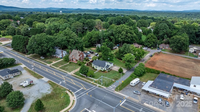 98 S Main St, Granite Falls, NC 28630 - aerial view of property's location featuring a heavily wooded area and a mountainous background