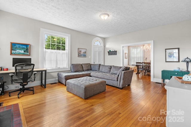 98 S Main St, Granite Falls, NC 28630 - living area with a desk, light wood-style floors, a textured ceiling, and a chandelier