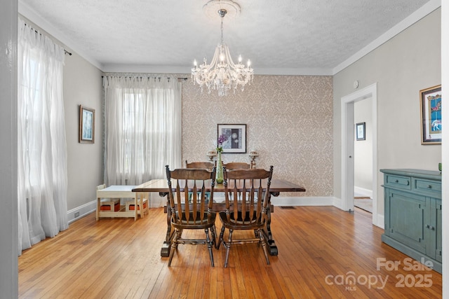 98 S Main St, Granite Falls, NC 28630 - dining room featuring a textured ceiling, a chandelier, hardwood / wood-style floors, and ornamental molding