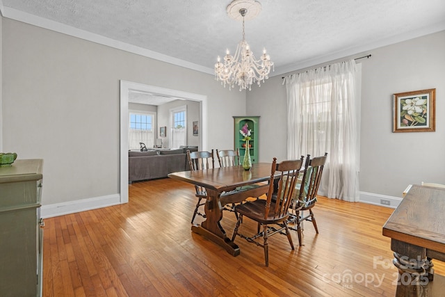 98 S Main St, Granite Falls, NC 28630 - dining room featuring a textured ceiling, light wood finished floors, and a chandelier