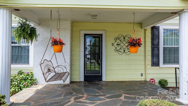 98 S Main St, Granite Falls, NC 28630 - view of exterior entry featuring covered porch and brick siding