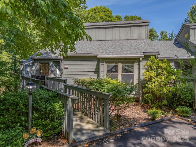 128 Quail Run Ct Unit 1627, Lake Lure, NC 28746 - rear view of property with a shingled roof and a wooden deck