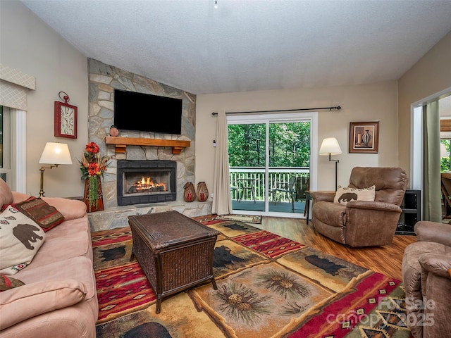 128 Quail Run Ct Unit 1627, Lake Lure, NC 28746 - living area featuring a fireplace, wood finished floors, and plenty of natural light