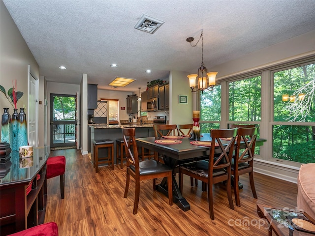 128 Quail Run Ct Unit 1627, Lake Lure, NC 28746 - dining space featuring a textured ceiling, dark wood-style floors, recessed lighting, a chandelier, and baseboards