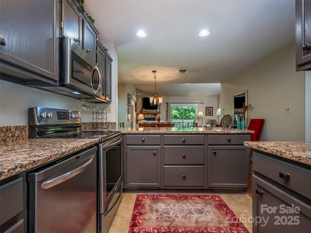 128 Quail Run Ct Unit 1627, Lake Lure, NC 28746 - kitchen featuring appliances with stainless steel finishes, gray cabinetry, a peninsula, light stone counters, and recessed lighting