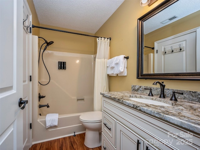 128 Quail Run Ct Unit 1627, Lake Lure, NC 28746 - full bath featuring vanity, wood finished floors, a textured ceiling, toilet, and shower / bath combo