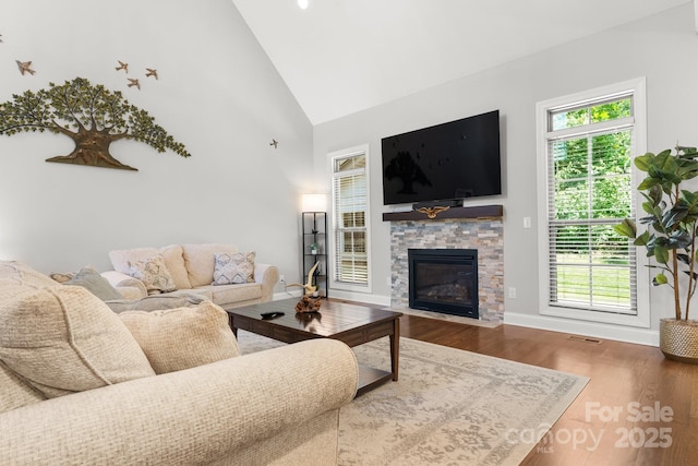 73 41st Ave NW, Hickory, NC 28601 - living area with wood finished floors, a stone fireplace, baseboards, and high vaulted ceiling