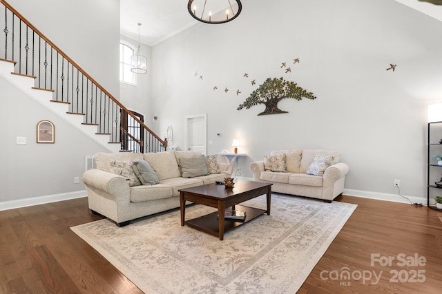 73 41st Ave NW, Hickory, NC 28601 - living room with a chandelier, a towering ceiling, baseboards, stairs, and crown molding