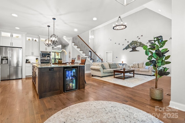 73 41st Ave NW, Hickory, NC 28601 - kitchen featuring appliances with stainless steel finishes, beverage cooler, a chandelier, white cabinets, and recessed lighting