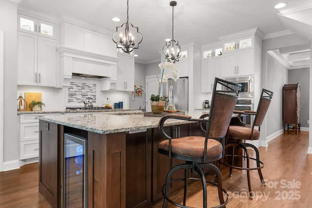 73 41st Ave NW, Hickory, NC 28601 - kitchen with wine cooler, stainless steel appliances, recessed lighting, a kitchen island with sink, and white cabinets