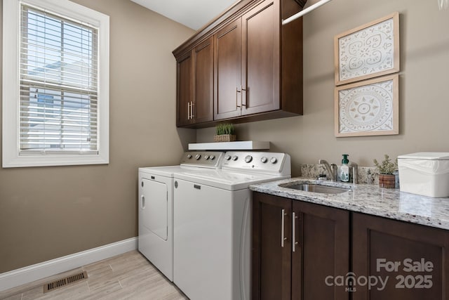 73 41st Ave NW, Hickory, NC 28601 - laundry area with separate washer and dryer, cabinet space, baseboards, and light wood-type flooring
