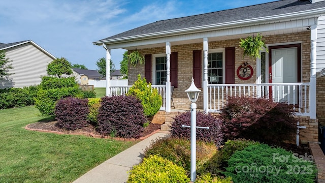 10 Hunters Ridge Ct, Granite Falls, NC 28630 - entrance to property featuring a porch, a yard, roof with shingles, and brick siding