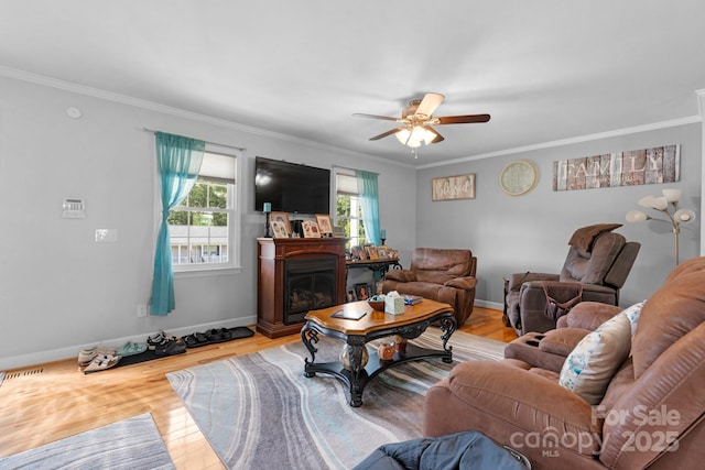 10 Hunters Ridge Ct, Granite Falls, NC 28630 - living area featuring ceiling fan, crown molding, wood finished floors, baseboards, and a glass covered fireplace