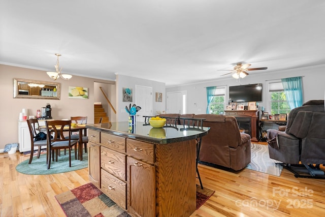 10 Hunters Ridge Ct, Granite Falls, NC 28630 - kitchen featuring ornamental molding, light wood-style floors, a center island, dark countertops, and a ceiling fan