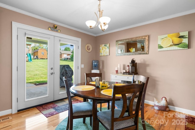 10 Hunters Ridge Ct, Granite Falls, NC 28630 - dining room with french doors, a chandelier, ornamental molding, light wood finished floors, and baseboards