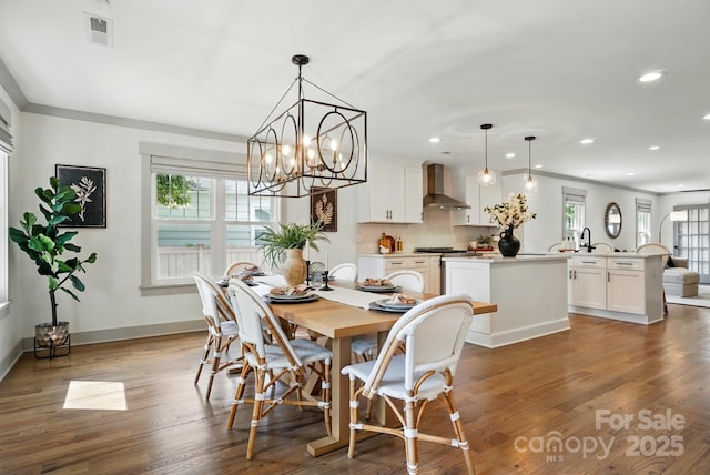 343 Melbourne Ct, Charlotte, NC 28209 - dining space with recessed lighting, plenty of natural light, wood finished floors, baseboards, and a chandelier