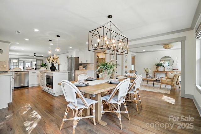 343 Melbourne Ct, Charlotte, NC 28209 - dining space featuring recessed lighting, wood finished floors, a chandelier, and ceiling fan