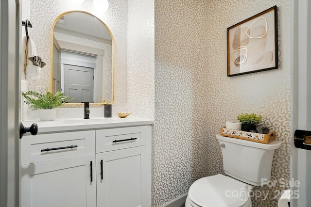 343 Melbourne Ct, Charlotte, NC 28209 - half bath featuring wallpapered walls, toilet, and vanity