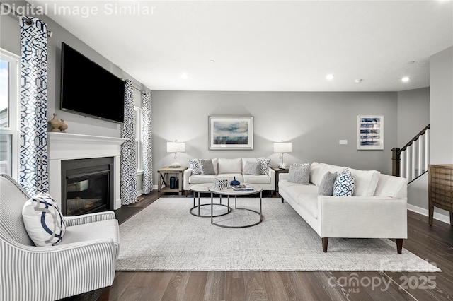 7335 Childress Dr, Concord, NC 28025 - living area featuring plenty of natural light, stairway, a glass covered fireplace, recessed lighting, and dark wood finished floors