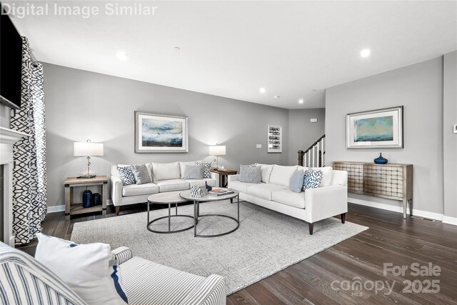 7335 Childress Dr, Concord, NC 28025 - living room featuring dark wood-style flooring, stairs, recessed lighting, baseboards, and a fireplace