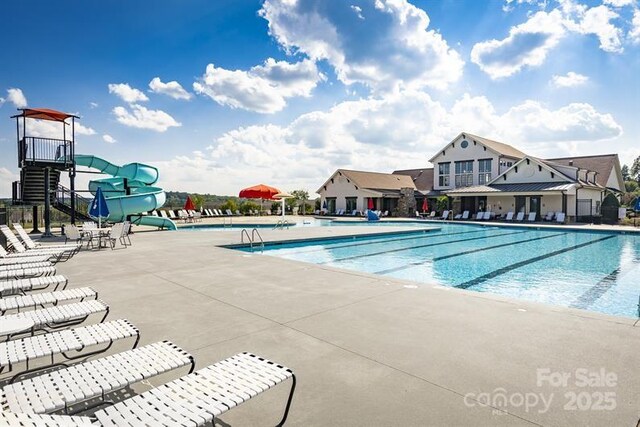 7335 Childress Dr, Concord, NC 28025 - community pool with a water slide and a patio area