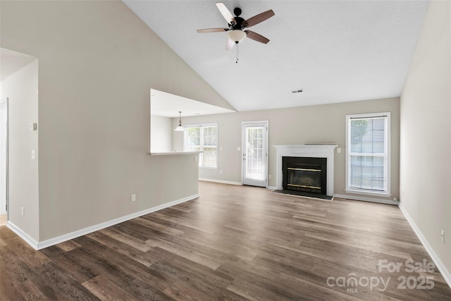 370 Running Briar Rd, Fletcher, NC 28732 - unfurnished living room featuring wood finished floors, a fireplace with flush hearth, baseboards, ceiling fan, and high vaulted ceiling