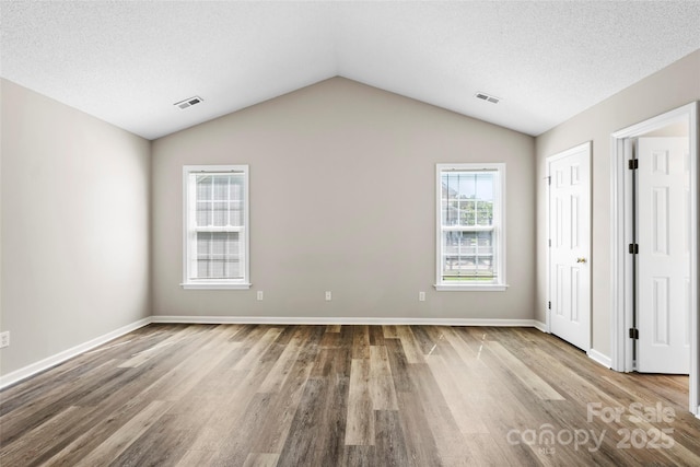 370 Running Briar Rd, Fletcher, NC 28732 - unfurnished bedroom featuring wood finished floors, lofted ceiling, and baseboards